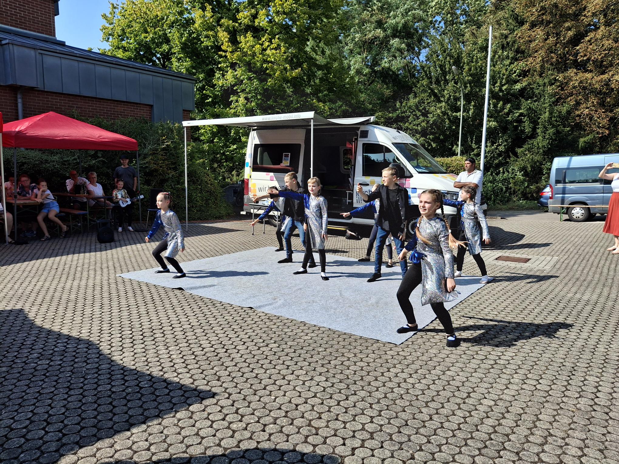 Interkulturelle Begegnung mit ukrainischen Tänzen vor der Begegnungskirche in Köllerbach.