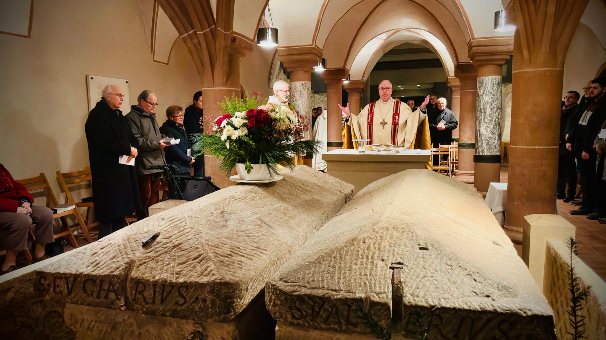 Bischof Stephan Ackermann beim Gebet vor den Gräbern der Bischöfe Eucharius und Valerius, deren Sarkophage sich in der Krypta befinden.