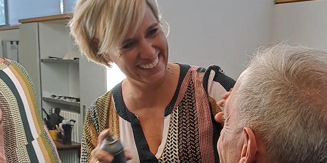 Maskenbildnerin Katja Texter benutzt das Make-up Setting Spray an Pfarrer Benedikt Welter