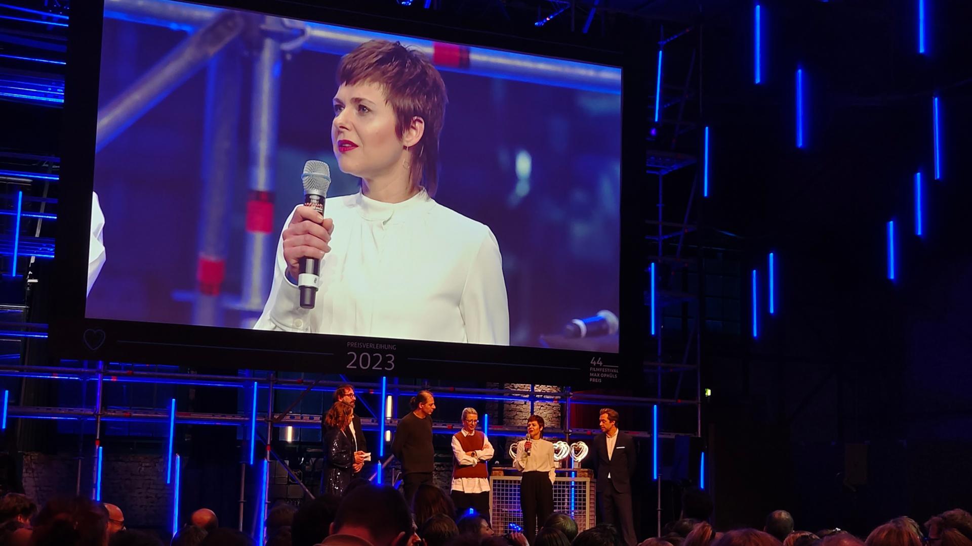 Die Ökumenische Jury beim Max-Ophüls-Filmfestival 2023, Preisverleihung im E-Werk (im Screen das saarländische Jury-Mitglied Sabrina Maas) (v.l.), Foto: Wolf-Dieter Scheid