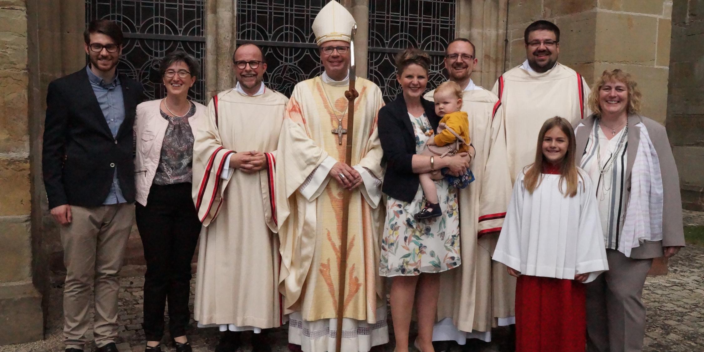 Mit ihren Familien und Bischof Stephan Ackermann freuen sich die neugeweihten ständigen Diakone Peter Kurtscheid, Sebastian Zinken und Michael Stephan (von links).